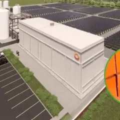 Nowoczesny magazyn energii z piasku, otoczony panelami słonecznymi. W tle cegły, symbolizujące budulec.